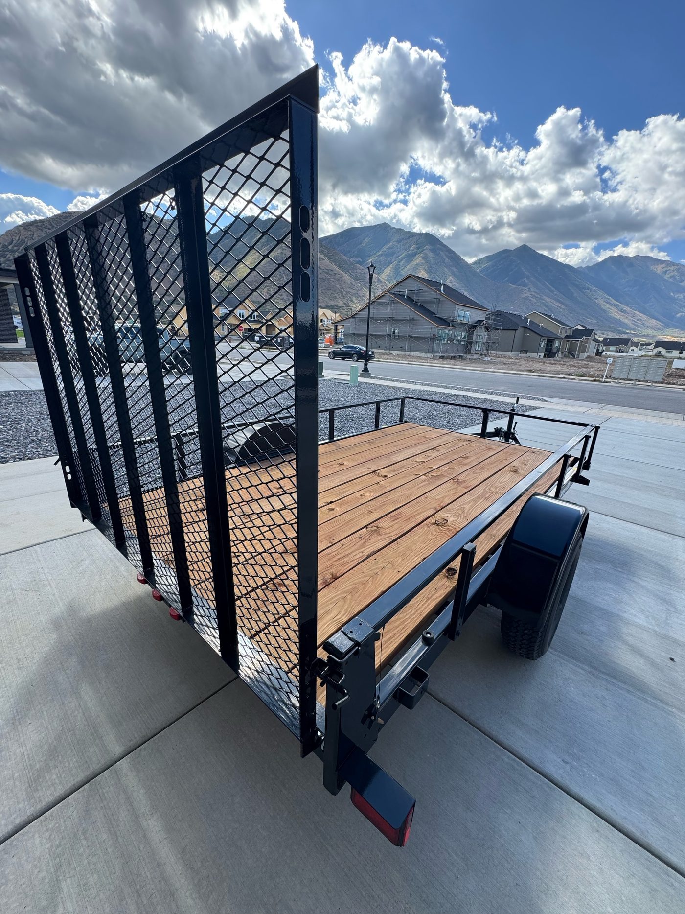 Carry-On 6x11 trailer from the rear with sides up and the ramp gate raised